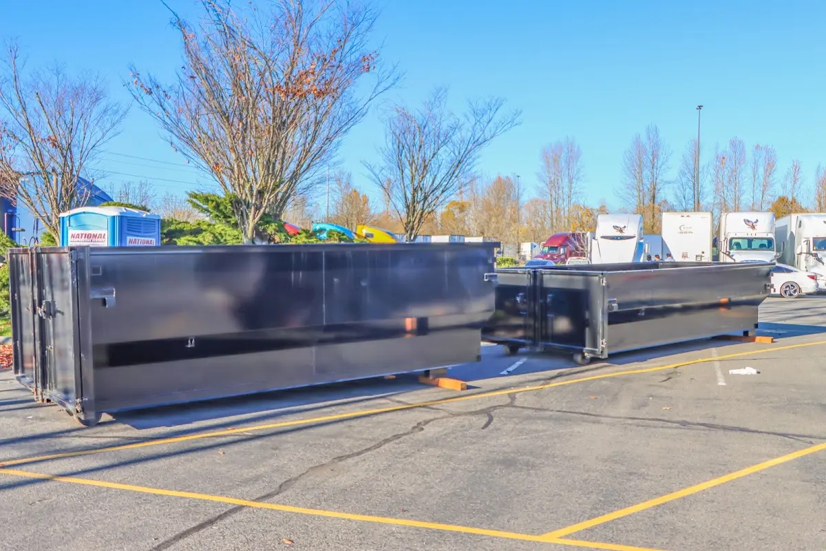 Professional dumpster rental service with roll-off container on residential driveway in East Bridgewater
